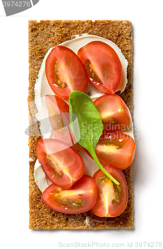 Image of crispbread with cream cheese and tomato pieces