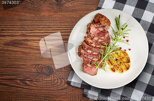 Image of grilled steak on white plate