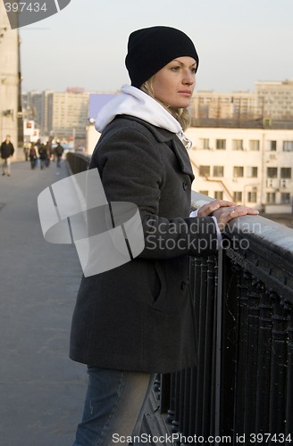 Image of The thoughtful pretty womanl on the bridge