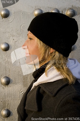 Image of The blonde on a background of a silvery wall