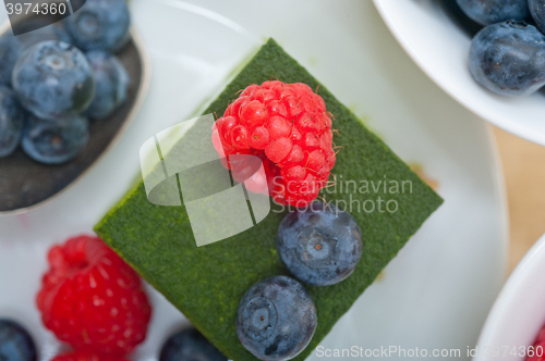 Image of green tea matcha mousse cake with berries