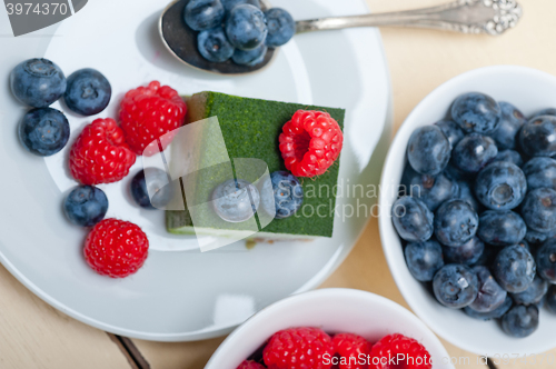 Image of green tea matcha mousse cake with berries