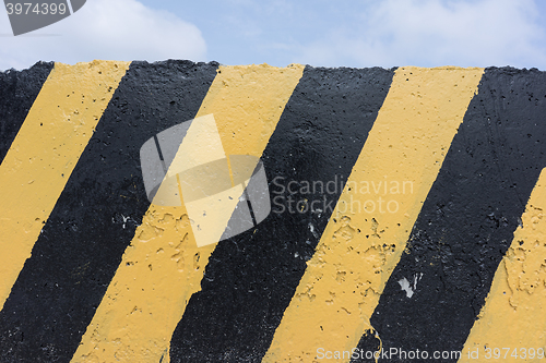 Image of Yellow and black concrete barrier