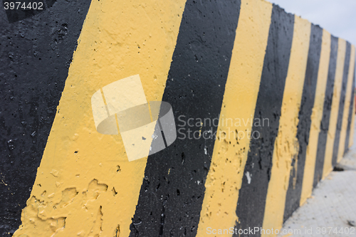 Image of Yellow and black concrete barrier