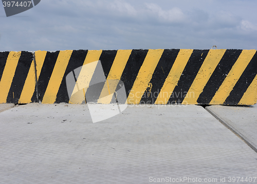 Image of Yellow and black concrete barrier