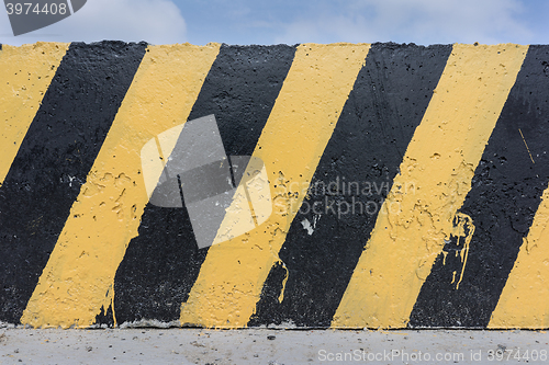 Image of Yellow and black concrete barrier