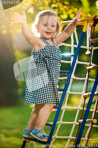 Image of The little baby girl playing at outdoor playground