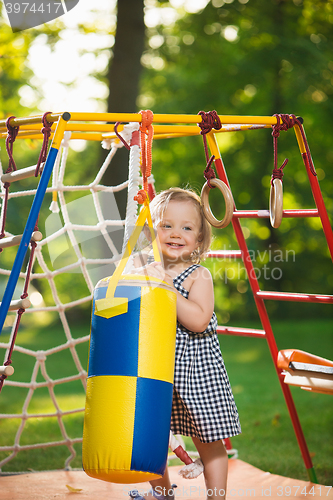 Image of The little baby girl playing at outdoor playground