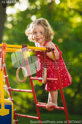 Image of The little baby girl playing at outdoor playground