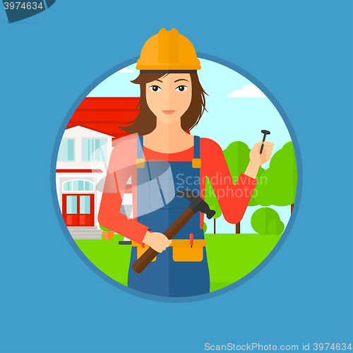 Image of Cheerful builder with hammer.