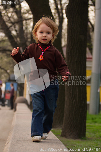 Image of Little girl running to photographer or audience.