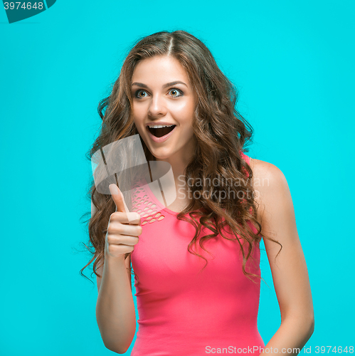 Image of Portrait of young woman with shocked facial expression