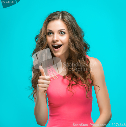 Image of Portrait of young woman with shocked facial expression