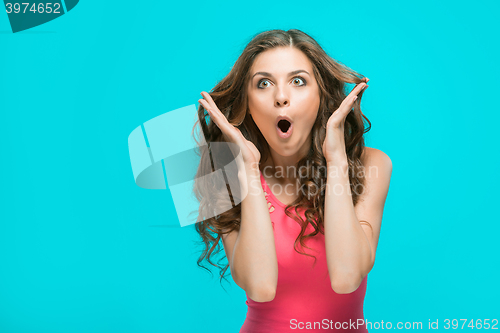 Image of Portrait of young woman with shocked facial expression