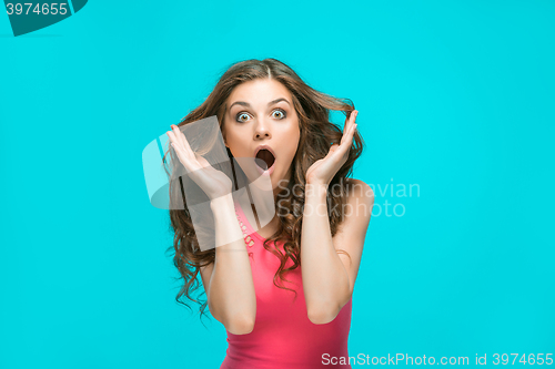 Image of Portrait of young woman with shocked facial expression