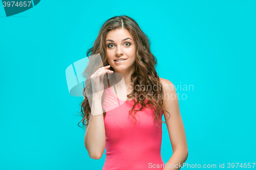 Image of Portrait of young woman with shocked facial expression