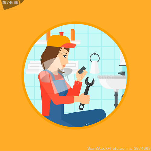 Image of Plumber fixing sink pipe with wrench.