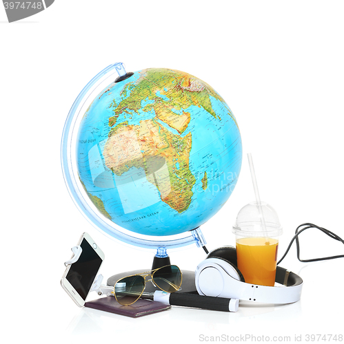 Image of The blue globe, phone, sunglasses and headphones on white background.