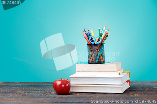 Image of Back to School concept. School Books, colored pencils and apple