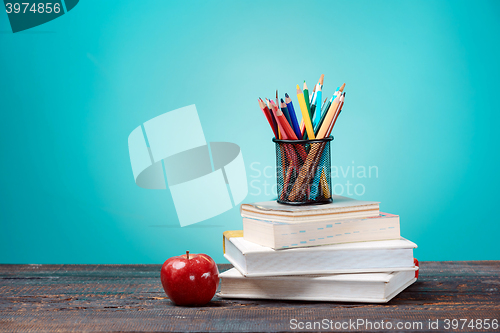 Image of Back to School concept. Books, colored pencils and apple