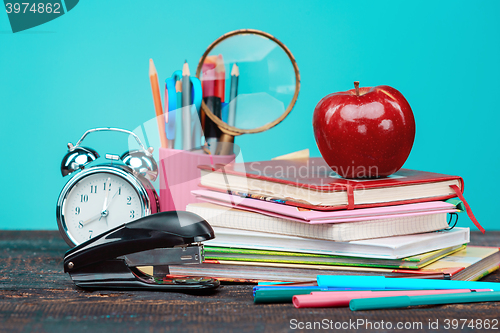 Image of Back to School concept. Books, colored pencils and clock