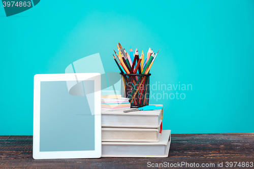 Image of Back to School concept. Books, colored pencils and laptop