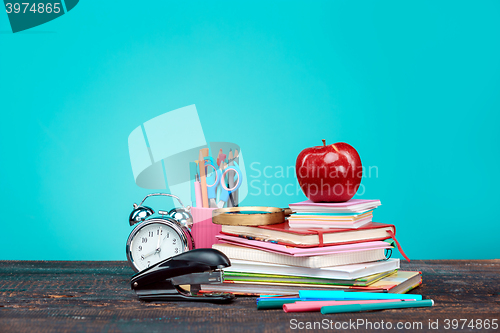 Image of Back to School concept. Books, colored pencils and clock