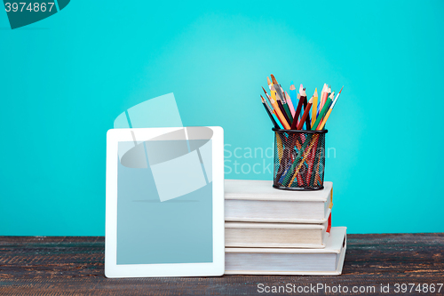 Image of Back to School concept. Books, colored pencils and laptop