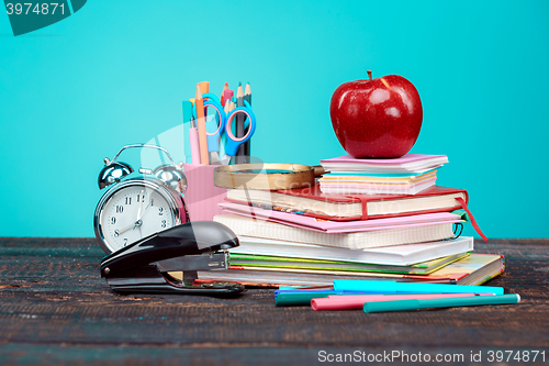 Image of Back to School concept. Books, colored pencils and clock