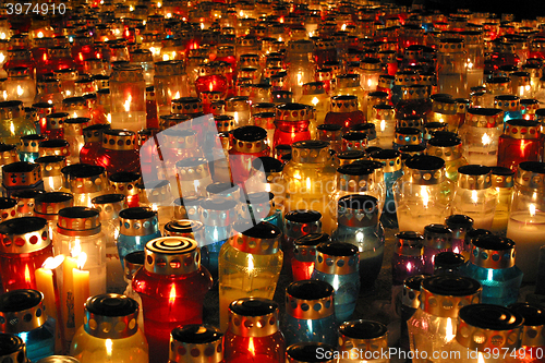 Image of Memorial candles shining at the cemetery on the All Saints Day