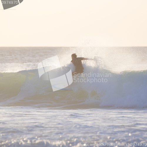 Image of Surfer riding a big wave.