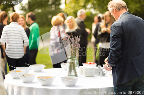 Image of Banquet lunch break at conference meeting on hotel terrace.