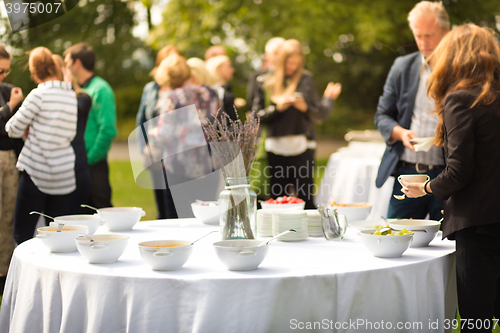 Image of Banquet lunch break at conference meeting on hotel terrace.