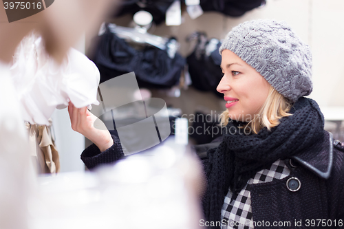 Image of Beautiful lady shopping in lingerie store.