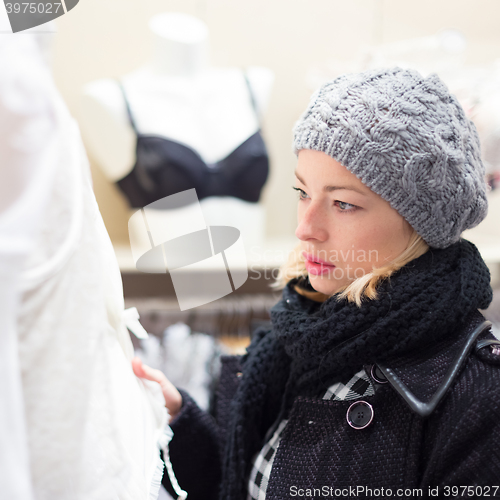 Image of Beautiful lady shopping in lingerie store.