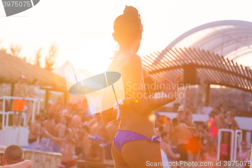 Image of Sexy girl dancing on a beach party.