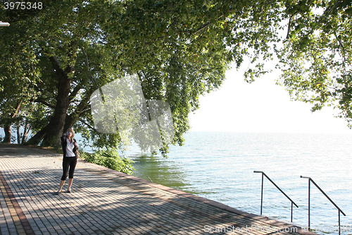 Image of Lady posing near lake