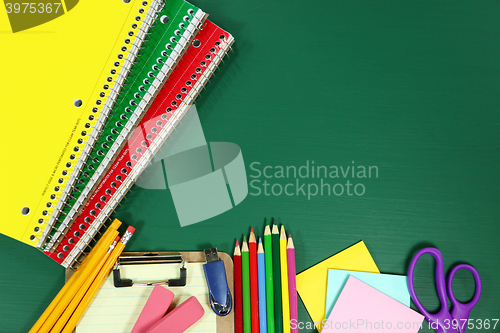 Image of School Supplies on Blank Chalkboard