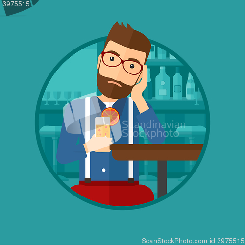 Image of Man drinking orange cocktail at the bar.