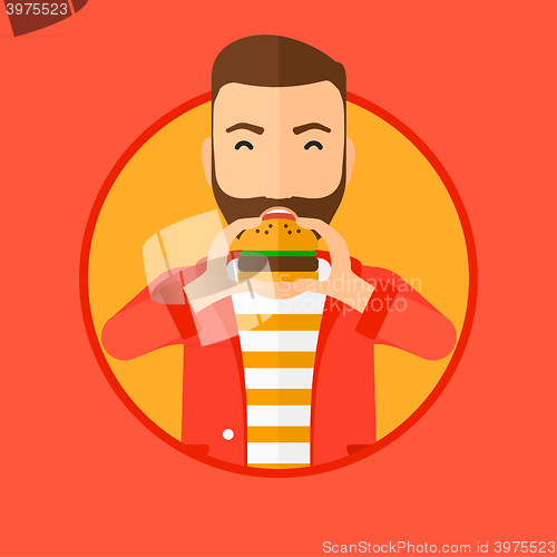 Image of Man eating hamburger.