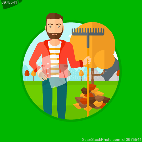 Image of Man raking autumn leaves.