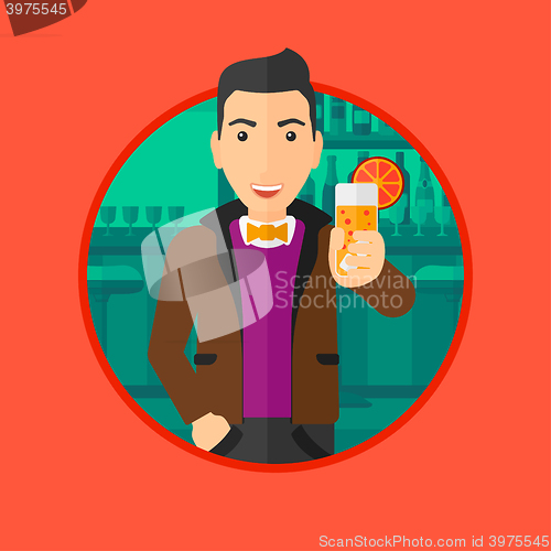 Image of Man drinking orange cocktail at the bar.