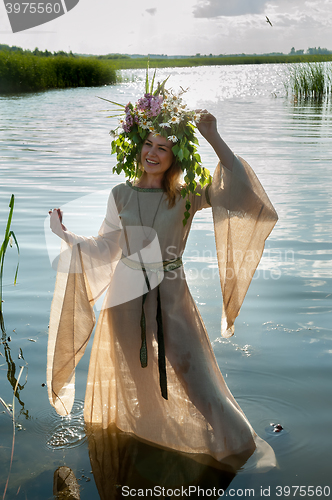 Image of Beautiful sad woman with flower wreath