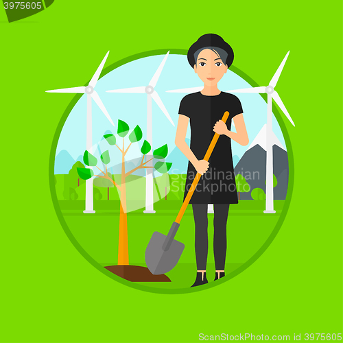 Image of Woman plants tree.