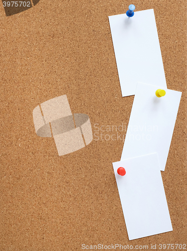 Image of Cork noticeboard with three white cards pinned vertically