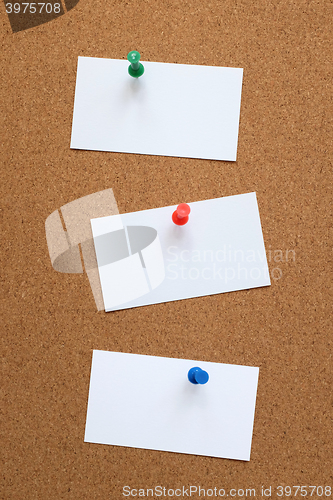 Image of Three blank cards pinned to a cork board