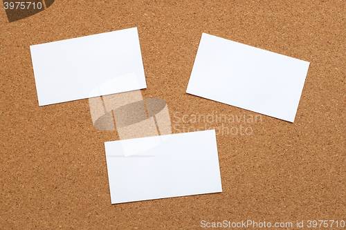 Image of Three blank cards on a cork board