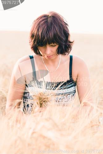 Image of Middle aged beauty woman in barley field