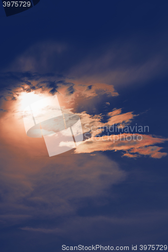 Image of sunset with sun clouds over clouds