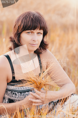 Image of Middle aged beauty woman in barley field